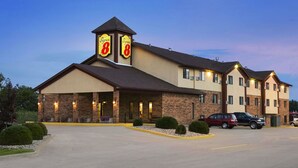 A Super 8 hotel with a brick facade, multiple windows, and a parking lot.