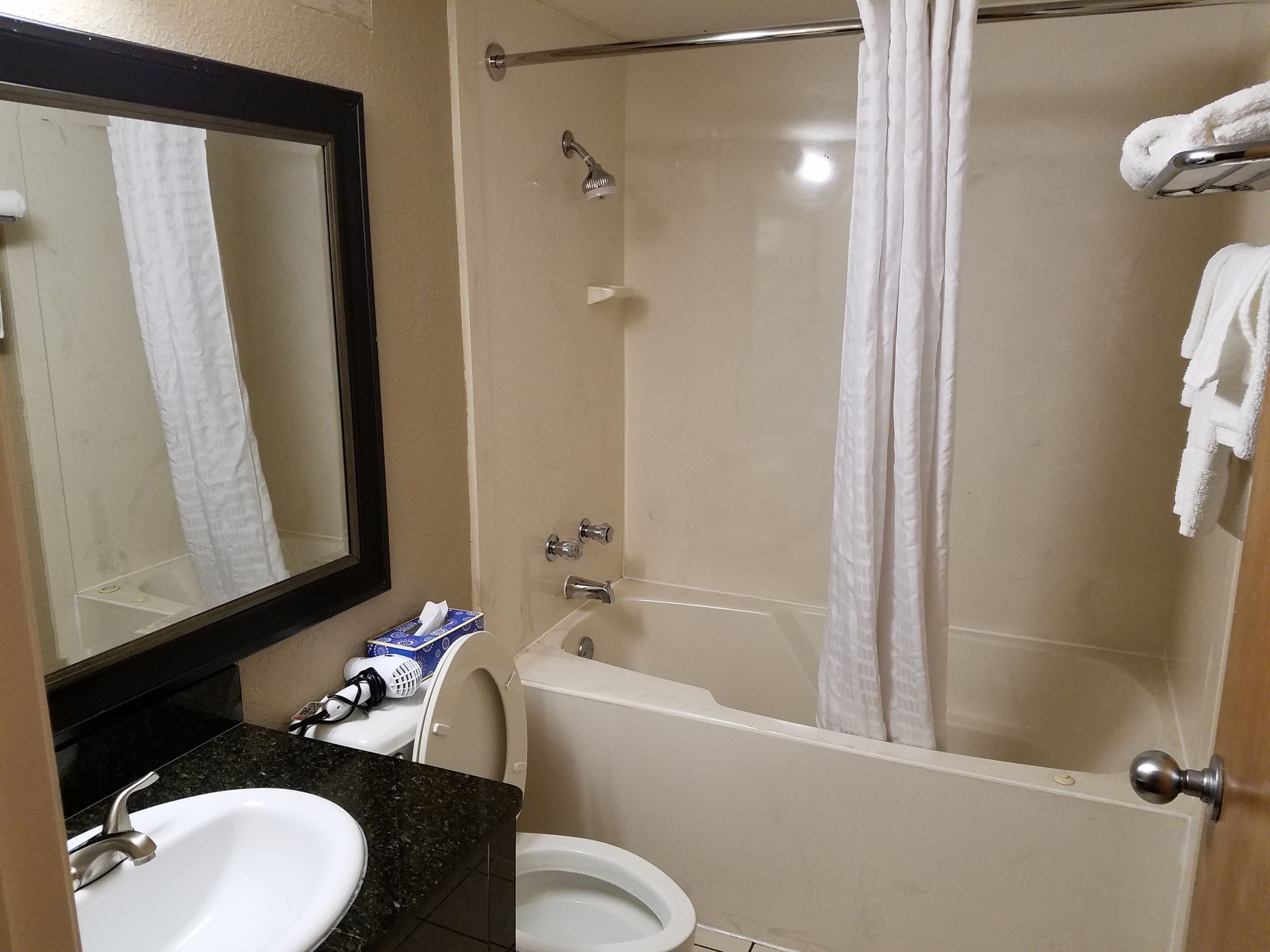 A bathroom with a sink, toilet, and bathtub.