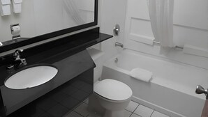A modern bathroom with two sinks, a toilet, and a bathtub. - Rodeway Inn & Suites Chandler - Phoenix South I-10 (Chandler)
