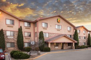 A hotel with a brick facade, multiple windows, and a sign indicating it is a Star 8 hotel.