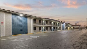 A motel with multiple floors, outdoor parking, and a gated entrance. - Travel Inn - In Phoenix (Alhambra) (Phoenix)