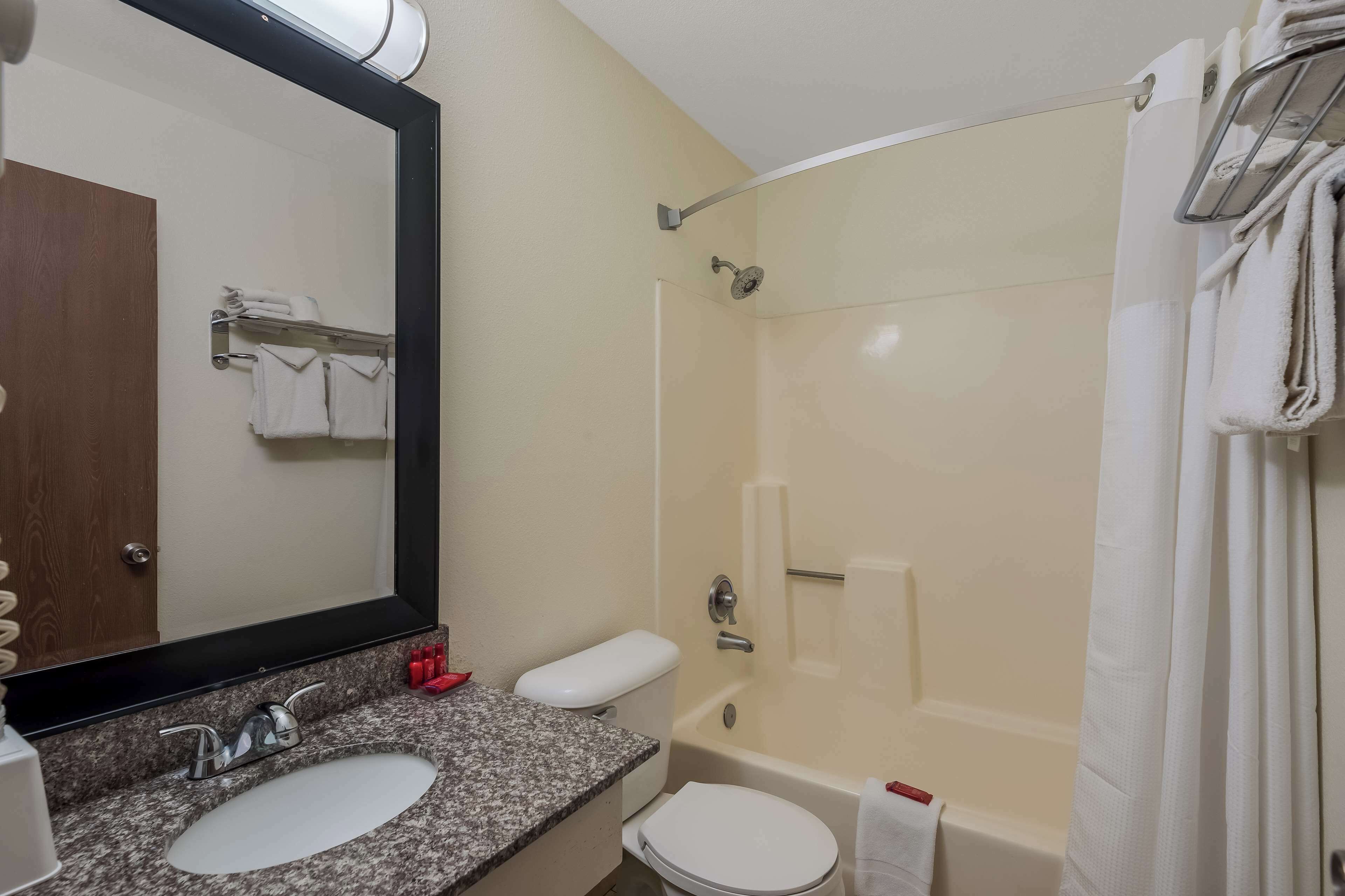 A bathroom with a sink, toilet, and bathtub.