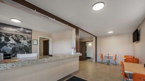A hotel reception area with a counter, seating area, and a mounted TV. - SureStay Hotel by Best Western Williams - Grand Canyon (Williams)
