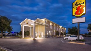 Un hôtel Super 8 doté d’une entrée bien éclairée, d’un parking et d’une grande enseigne.