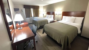A hotel room with two beds, a desk, a chair, a mirror, a lamp, and a nightstand with a phone. - Econo Lodge Cartersville-Emerson Lake Point (Cartersville)