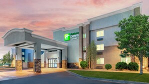 A hotel with a modern design, featuring a prominent Express & Suites sign.