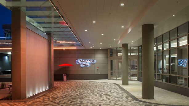 A hotel entrance with a 'Hampton Inn' sign, a glass door entrance, and a patterned floor. - Hampton Inn Washington DC NoMa Union Station (Washington)