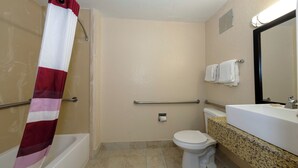 A bathroom with a shower, toilet, and sink. - Red Roof Inn Jacksonville - Cruise Port (Jacksonville)