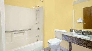 A bathroom with a bathtub, toilet, and sink.