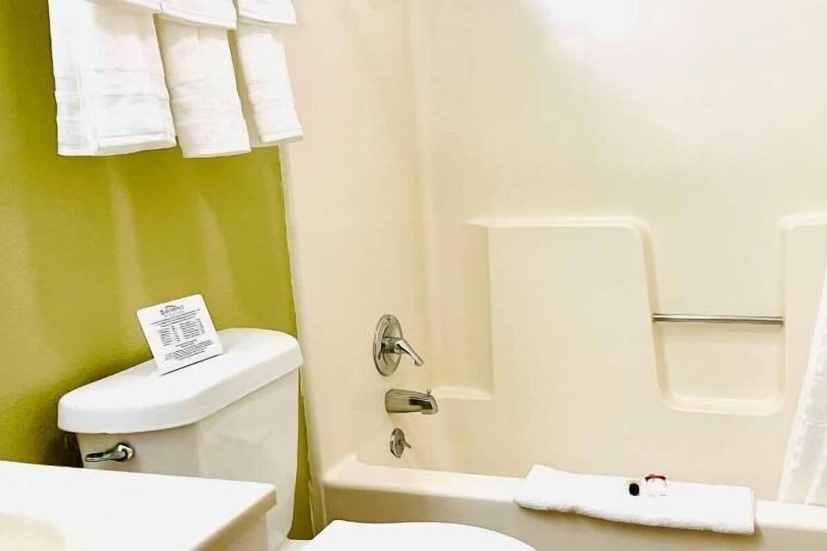 A bathroom with a toilet, a bathtub, and a sink.