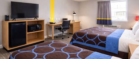 A hotel room with two beds, a desk, a television, a refrigerator, and a window with curtains.