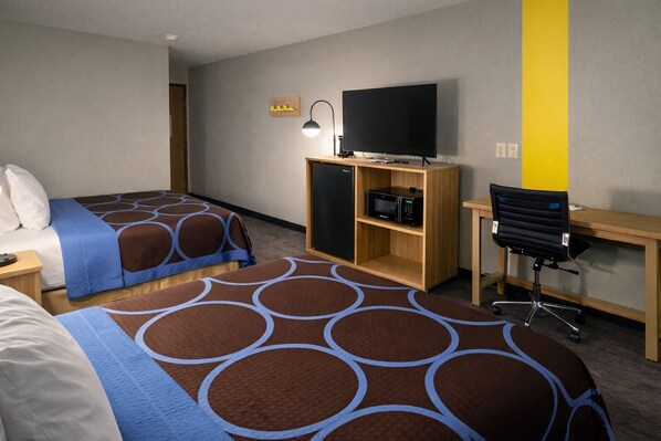 A hotel room with two beds, a desk, a chair, a television, and a microwave. - Super 8 by Wyndham Lewiston (Lewiston)