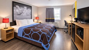 A hotel room with a bed, bedside tables, a TV, a desk, and a large window with curtains. - Super 8 by Wyndham Lewiston (Lewiston)