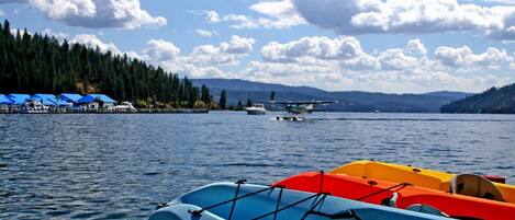 A lake with boats and a small airplane on the water.
