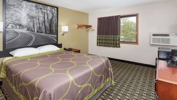 A hotel room with a bed, a large painting of a road, an air conditioning unit, and a window with curtains.