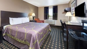 A hotel room with a large bed, a desk, a chair, a TV, and a window with curtains. - Super 8 by Wyndham Springfield East (Springfield)