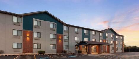 A multi-story hotel with a parking lot and handicap-accessible spaces.