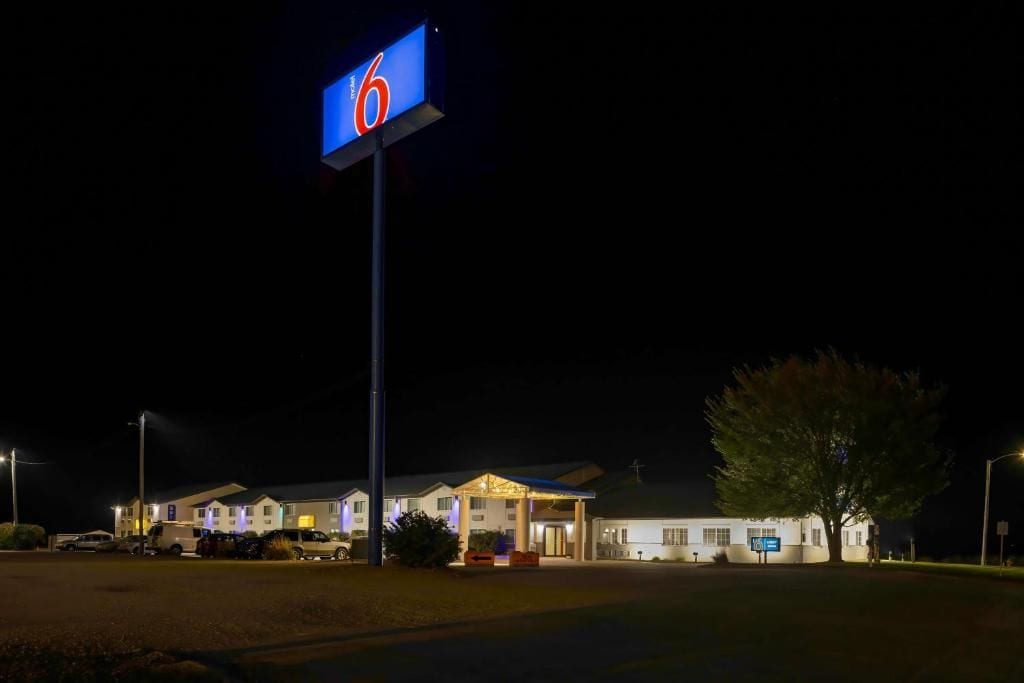 A motel with a prominent '6' sign, multiple buildings, and a parking area.