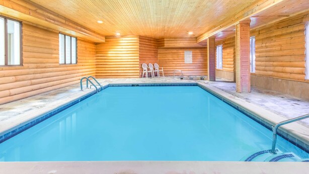 A wooden cabin with a swimming pool, wooden walls, and a ceiling with wooden beams. - Super 8 by Wyndham Buena Vista (Buena Vista)