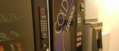 A vending machine area with a selection of snacks and a cold drink machine.