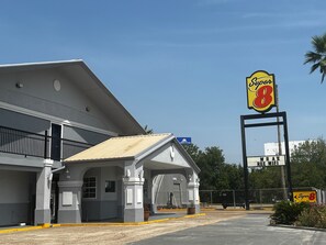 Guests can check in at this Super 8 motel, featuring a simple entrance area and parking lot.