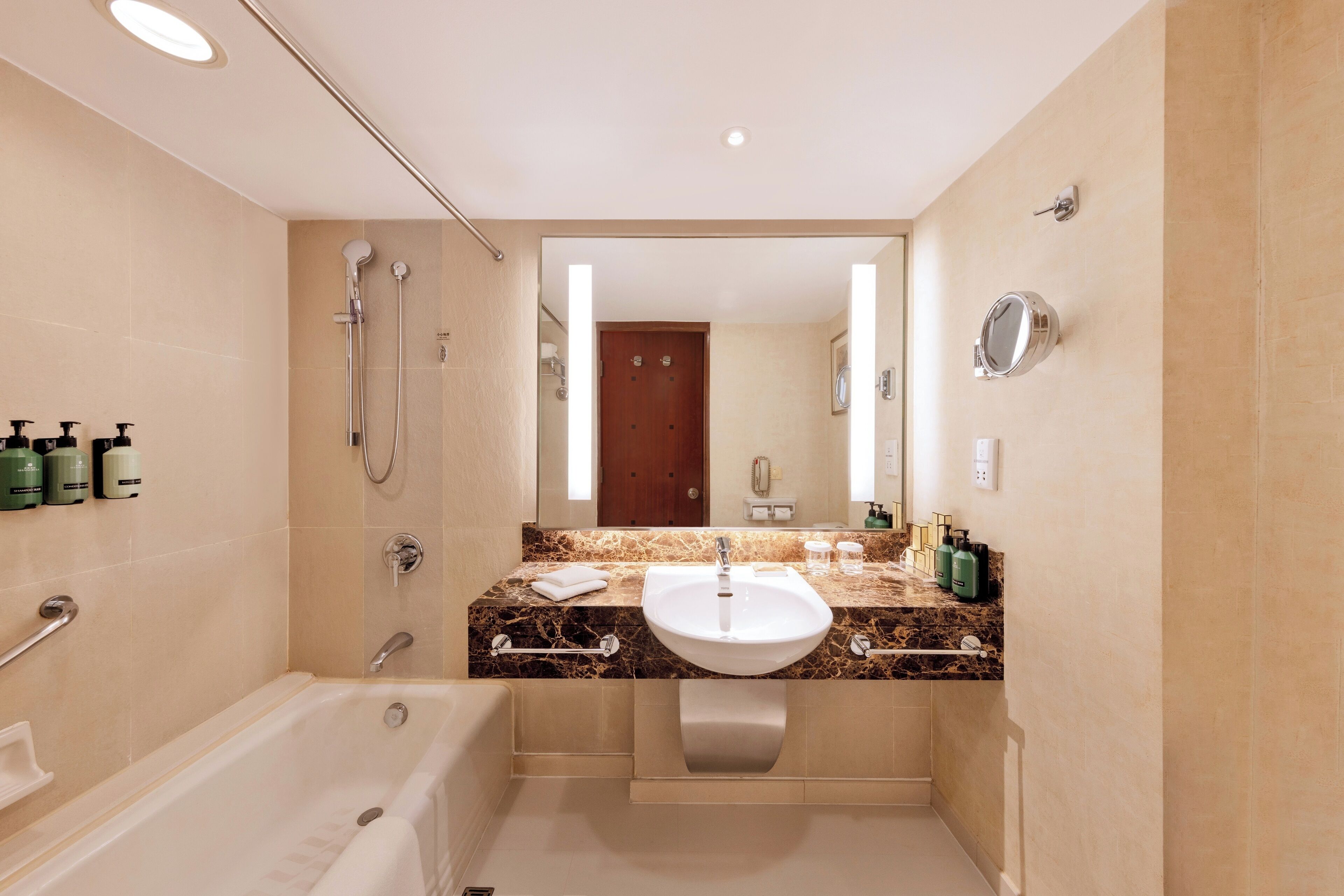 A modern bathroom with a bathtub, a sink, and a shower.