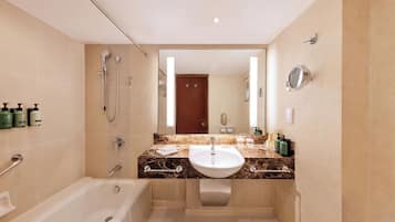 A modern bathroom with a bathtub, a sink, and a shower.
