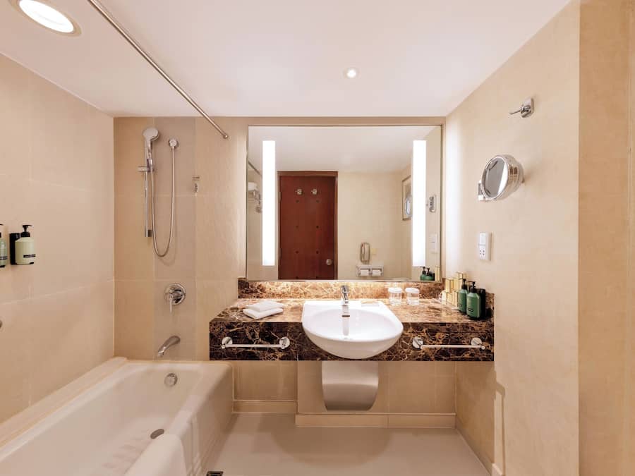 A modern bathroom with a bathtub, a sink, and a shower.