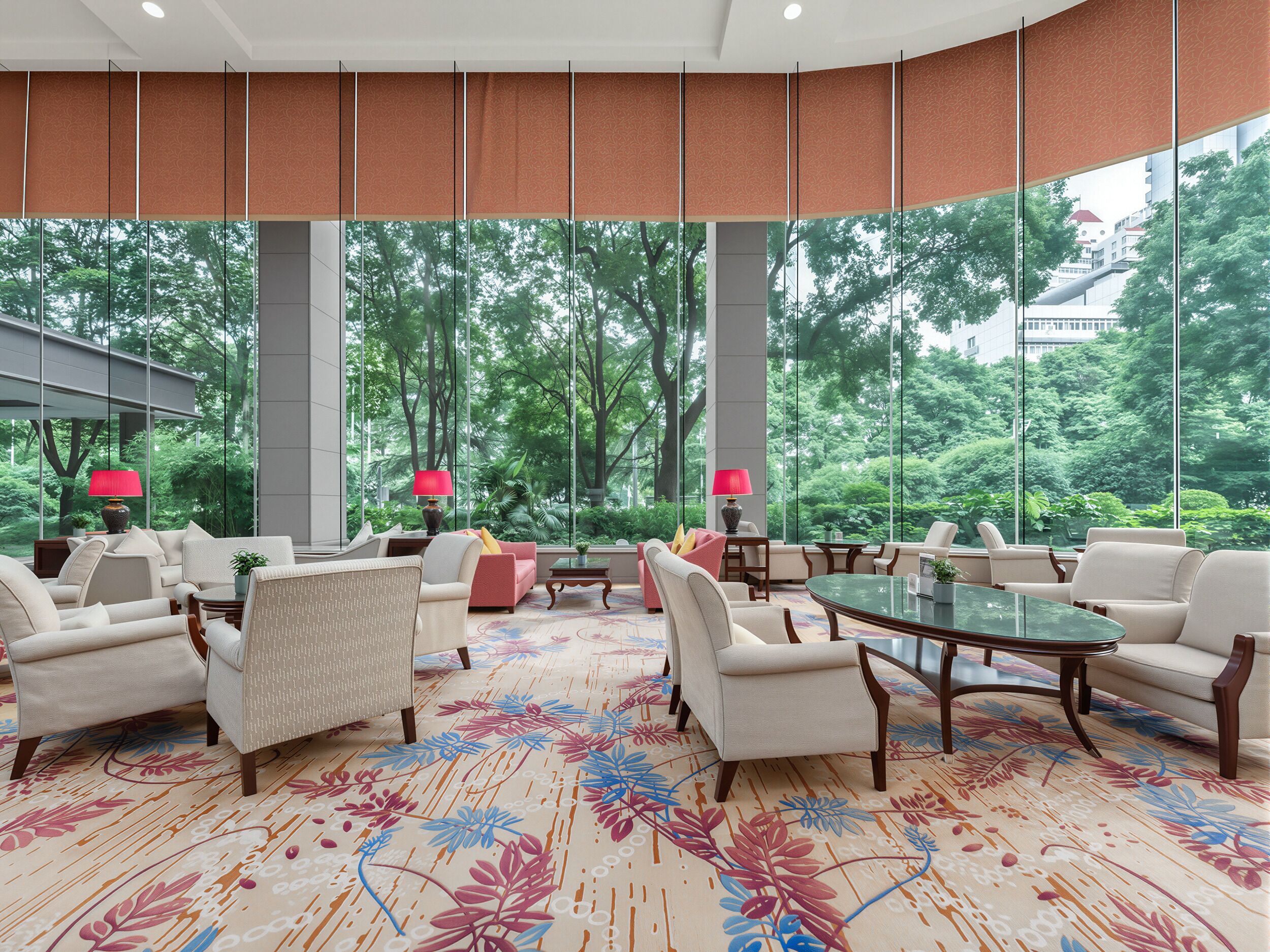 A spacious lobby with a large window offering a view of lush greenery, multiple seating areas with armchairs and sofas, and a patterned carpet.