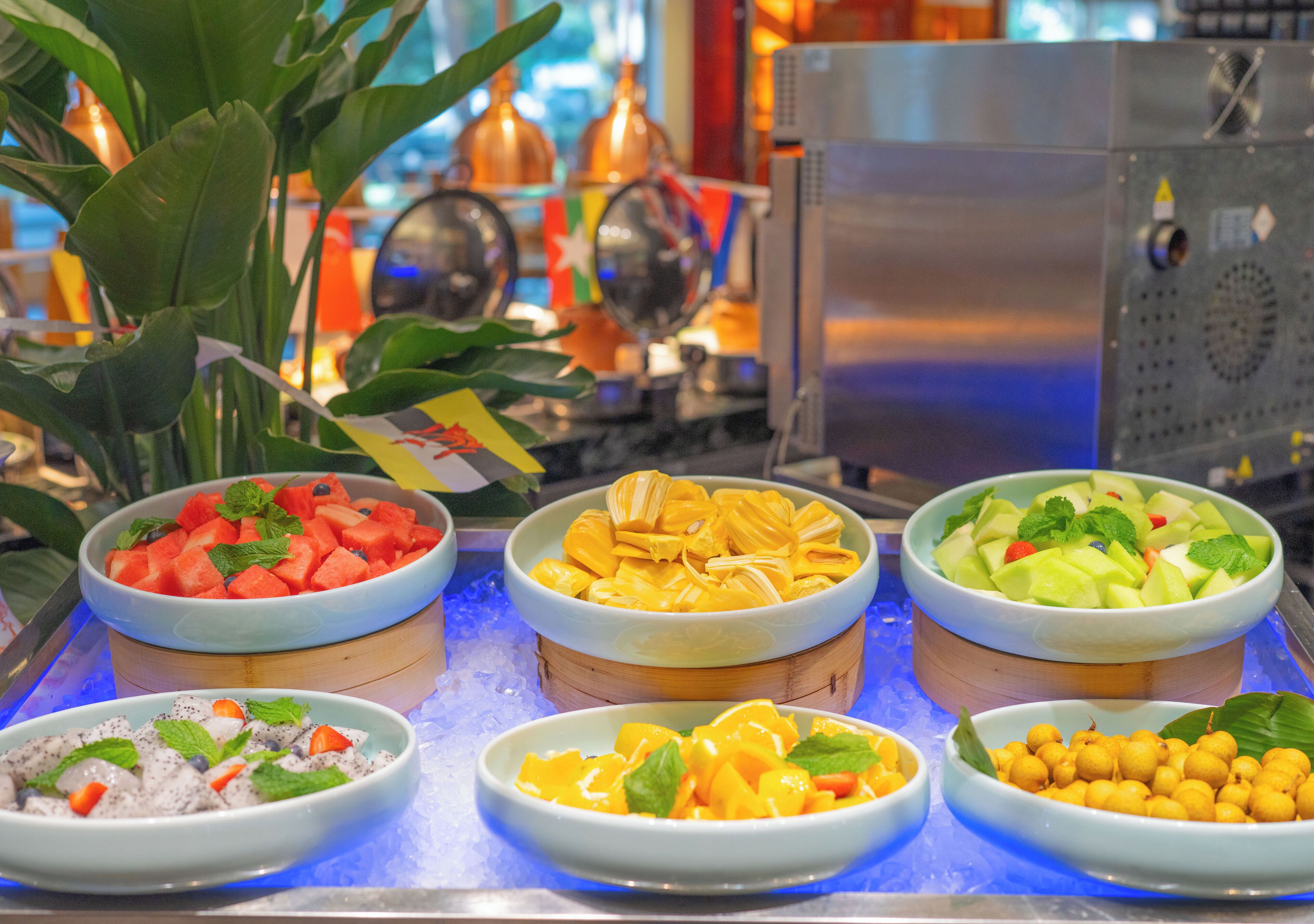 A buffet with various fruit and dessert options.
