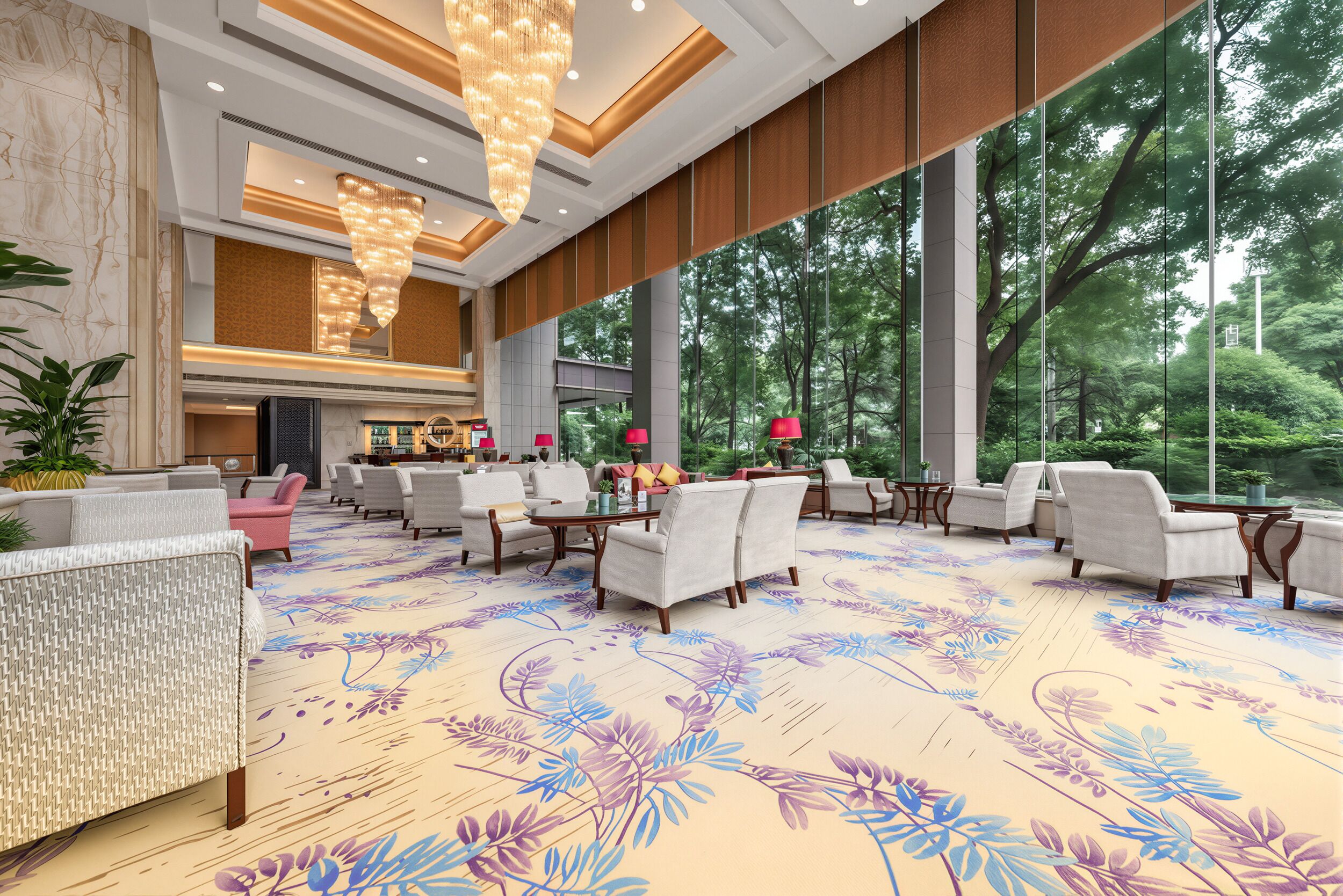 A spacious lobby with a floral carpet, seating area, and large windows offering a view of trees.
