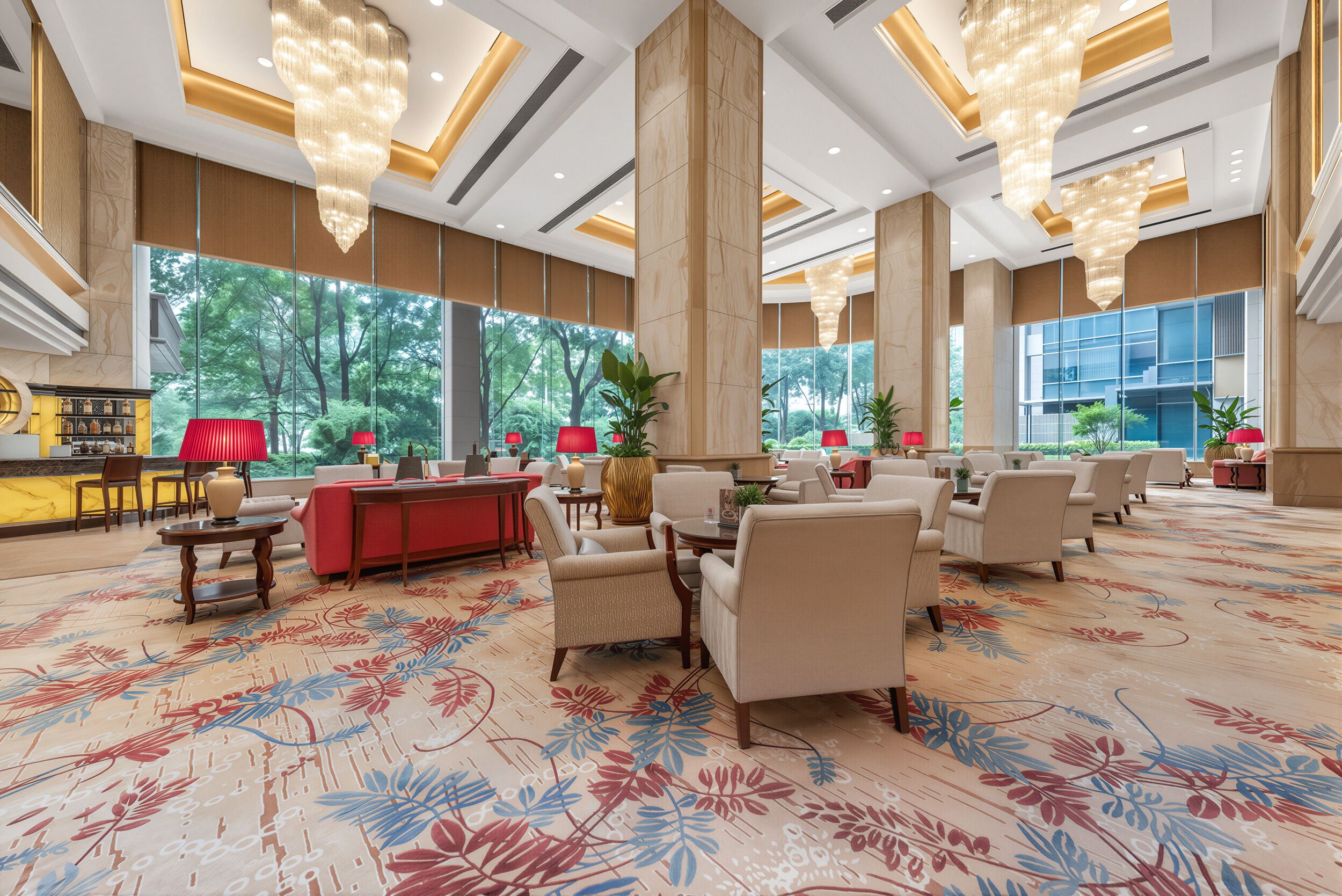 A spacious lobby with a central seating area, large windows, and a patterned carpet.