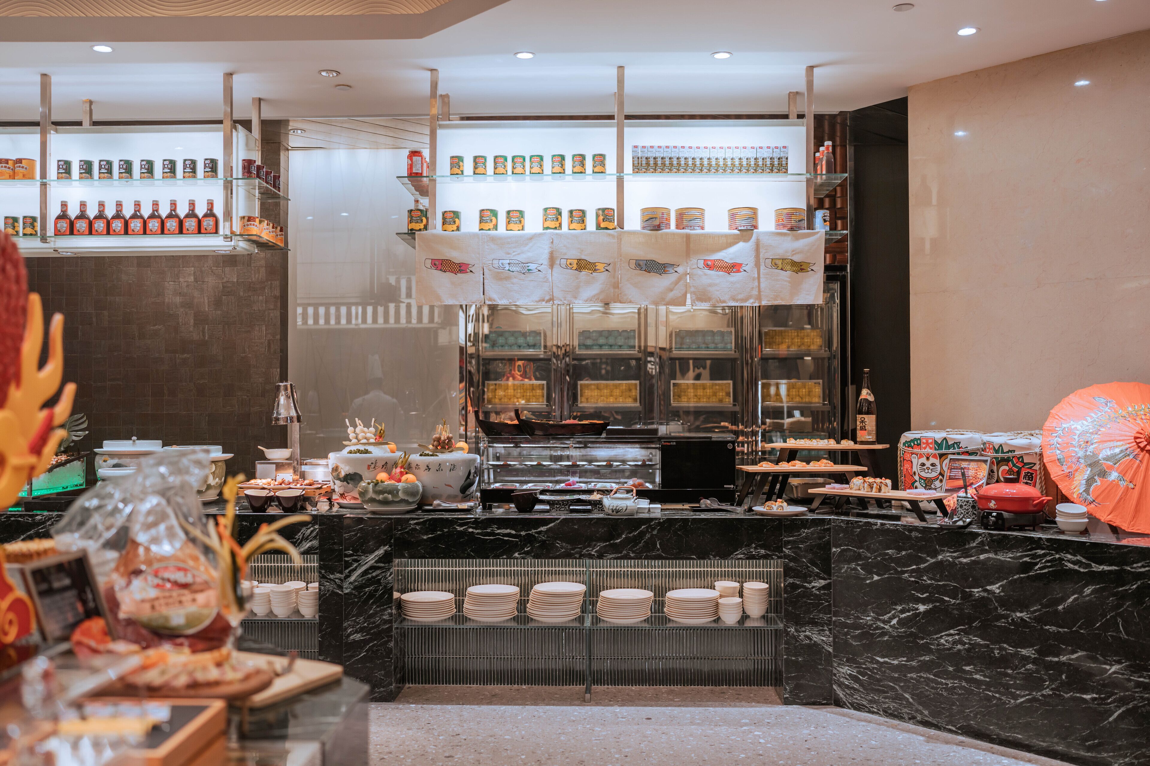 Un área de buffet bien organizada con diversos alimentos y aderezos.