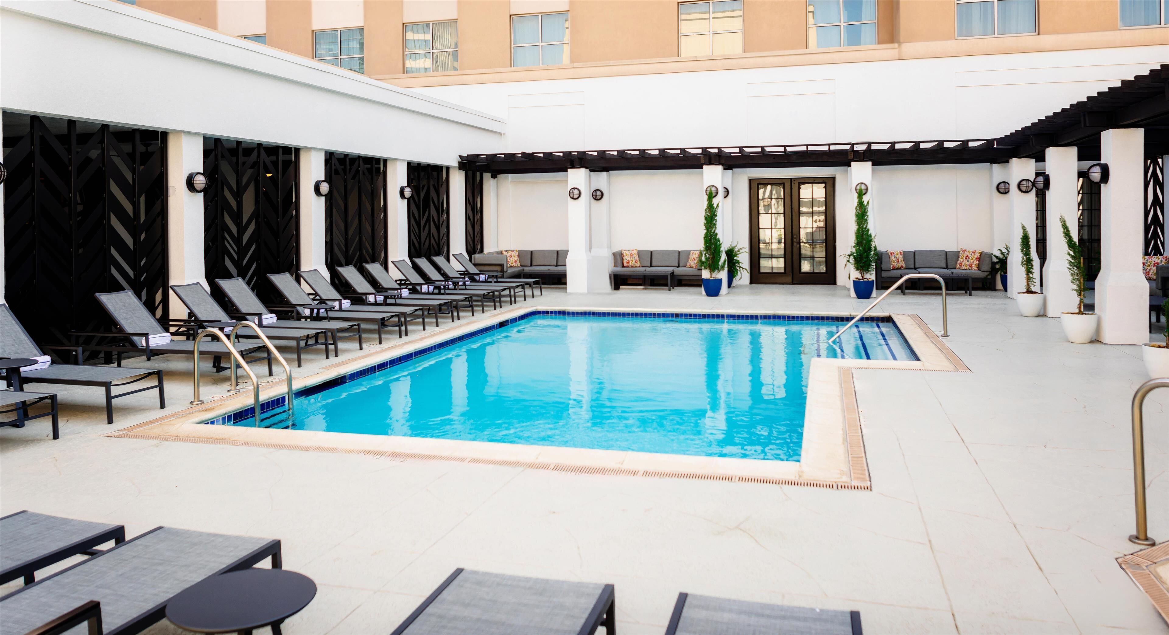 Outdoor pool, open 10:00 AM to 10:00 PM, pool loungers