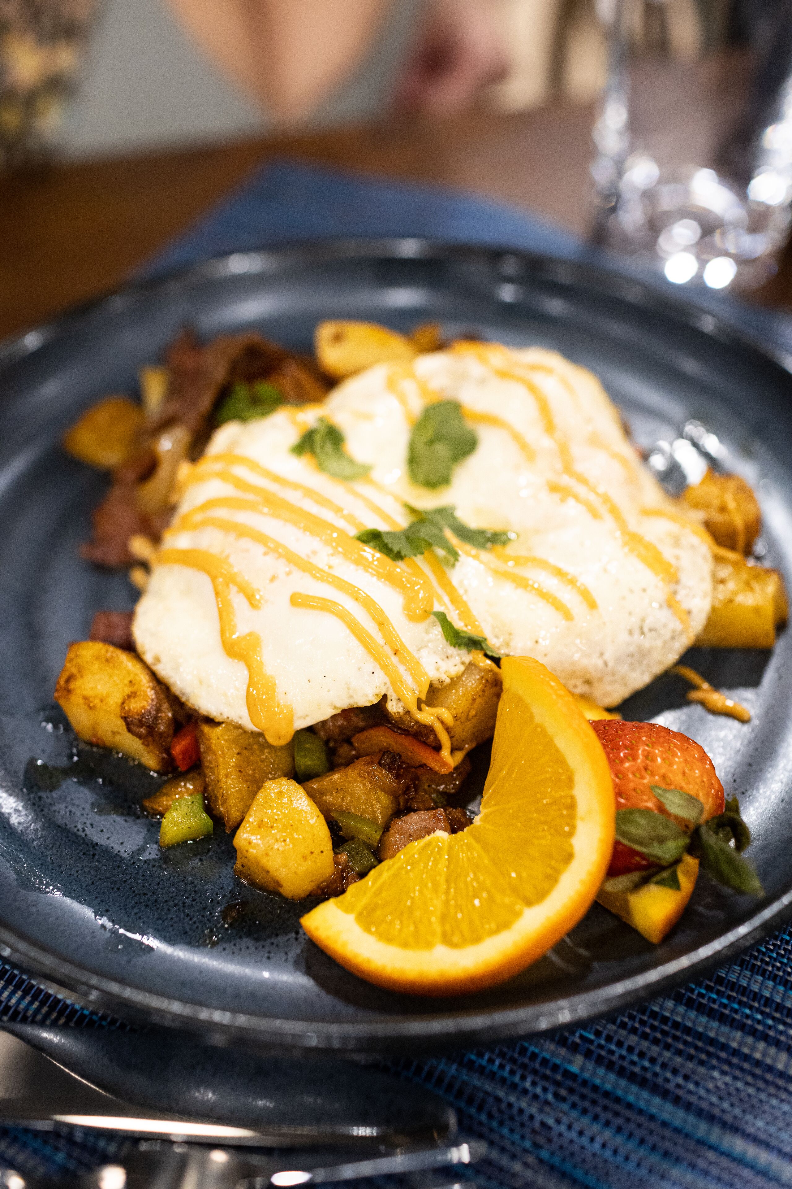 A plate of food with a white sauce and orange garnish.