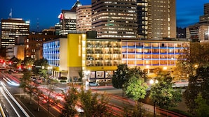 A hotel with multiple floors, large windows, and a prominent yellow section. - Staypineapple, Hotel Rose, Downtown Portland (Portland)