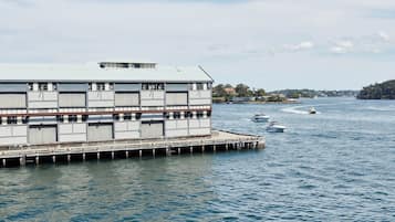 A waterfront building with multiple docked boats.