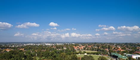 A residential area with houses, trees, and a clear blue sky.