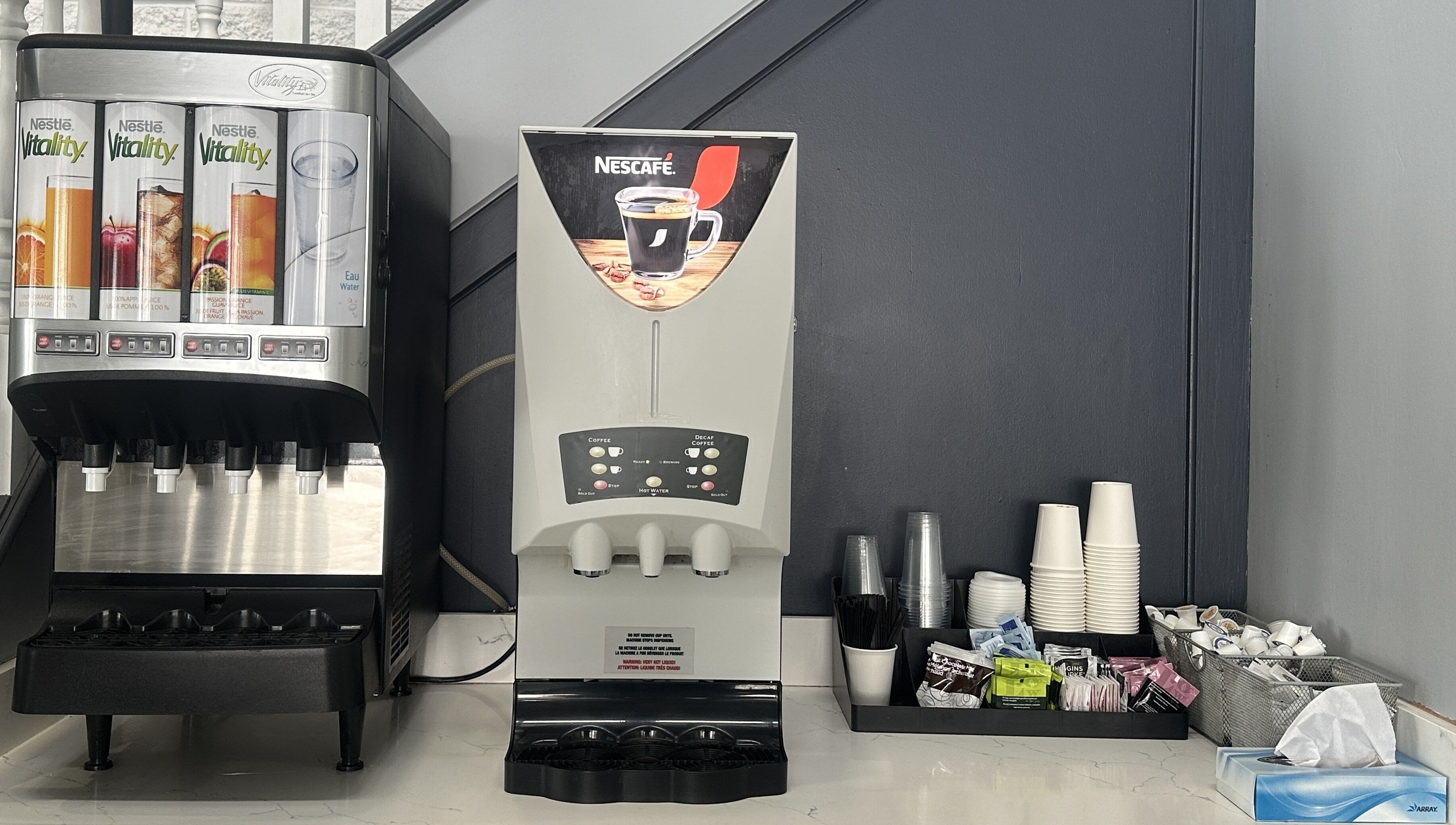 A coffee machine with options for coffee, decaf coffee, and hot water, along with a water dispenser.