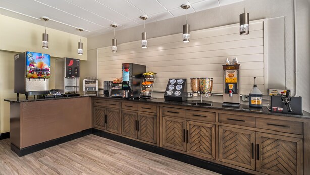 A modern kitchen with a coffee station, a refrigerator, and a microwave. - SureStay Hotel by Best Western Virginia Beach Royal Clipper (Virginia Beach)