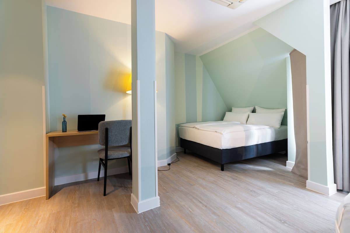 Ropa de cama hipoalergénica y caja de seguridad en la habitación