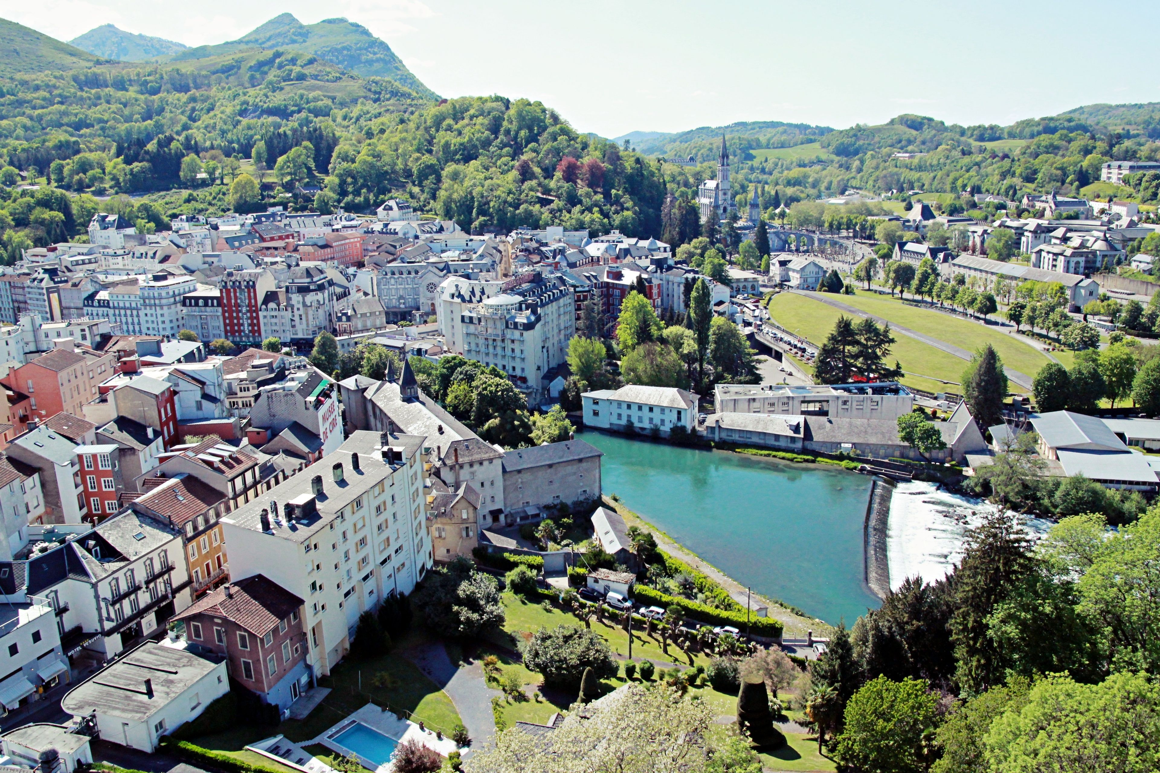 A town with a river, historic buildings, and a church.