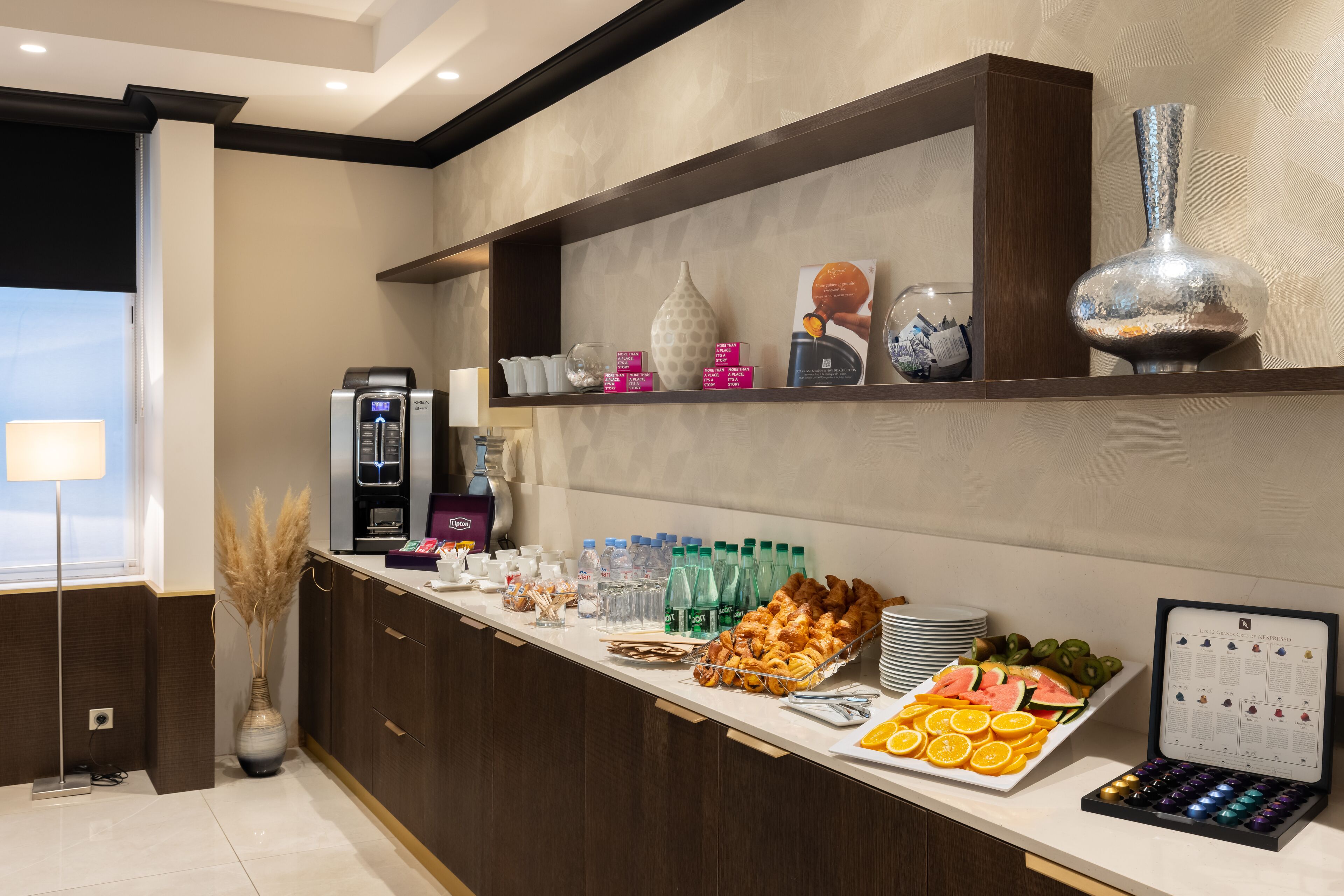 A breakfast buffet with various food items, beverages, and a coffee machine.