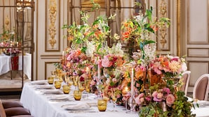 A banquet hall with ornate chandeliers, floral centerpieces, and elegant table settings. - Le Meurice - Dorchester Collection (Paris)