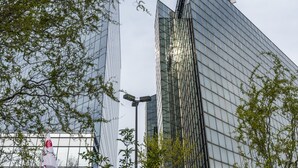 A modern glass building with a reflective facade, surrounded by trees. - Mercure Antwerp City South (Antwerp)