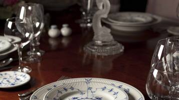 A dining table set with plates, glasses, and cutlery.