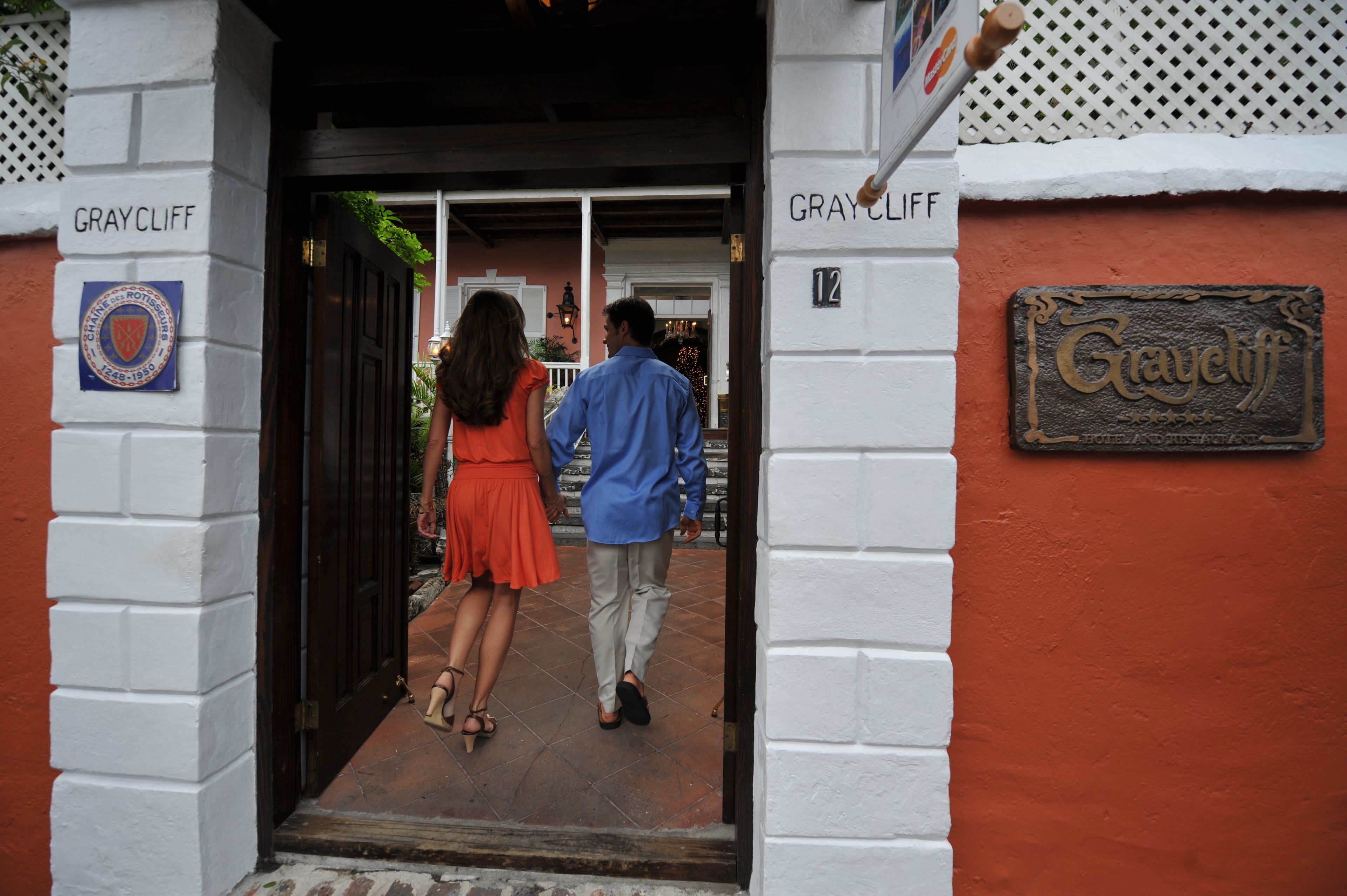 A hotel entrance with a sign reading "Graycliff" and a plaque with the hotel's name and establishment year.