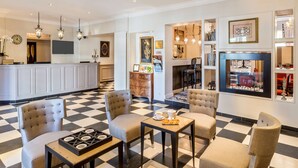 A hotel lobby with a checkered floor, seating area, kitchen, and a bar. - Best Western Plus Hotel Villa D'est (Strasbourg)