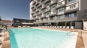 Seasonal outdoor pool, open 4:00 PM to 9:00 PM, pool umbrellas