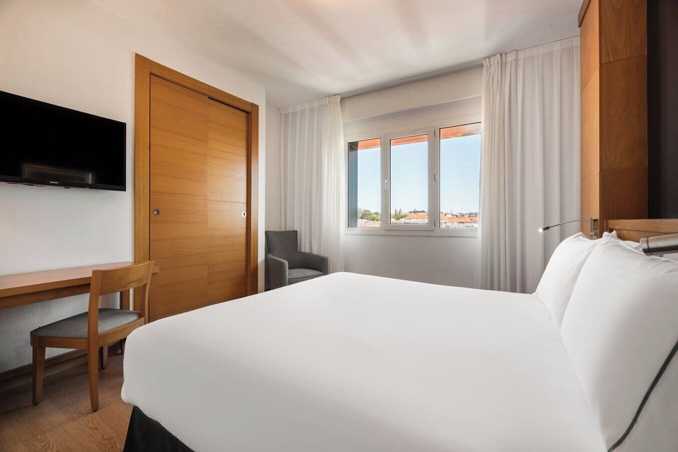 deluxe double room | minibar, desk, laptop workspace, blackout curtains